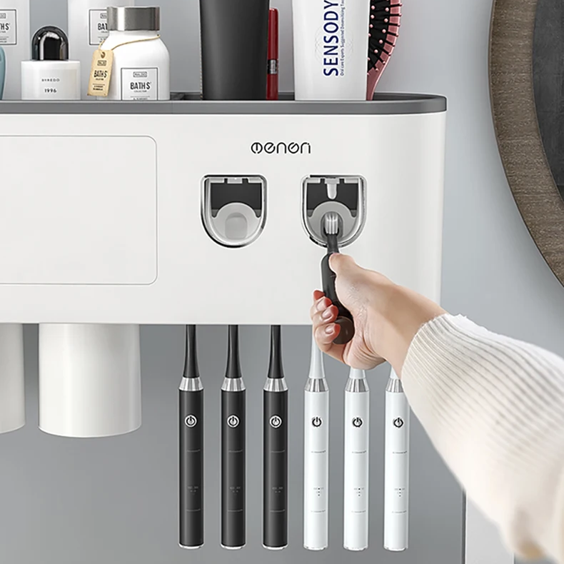 A hand pressing the dispenser to get toothpaste from the Ultimate Bathroom Toothbrush Organizer